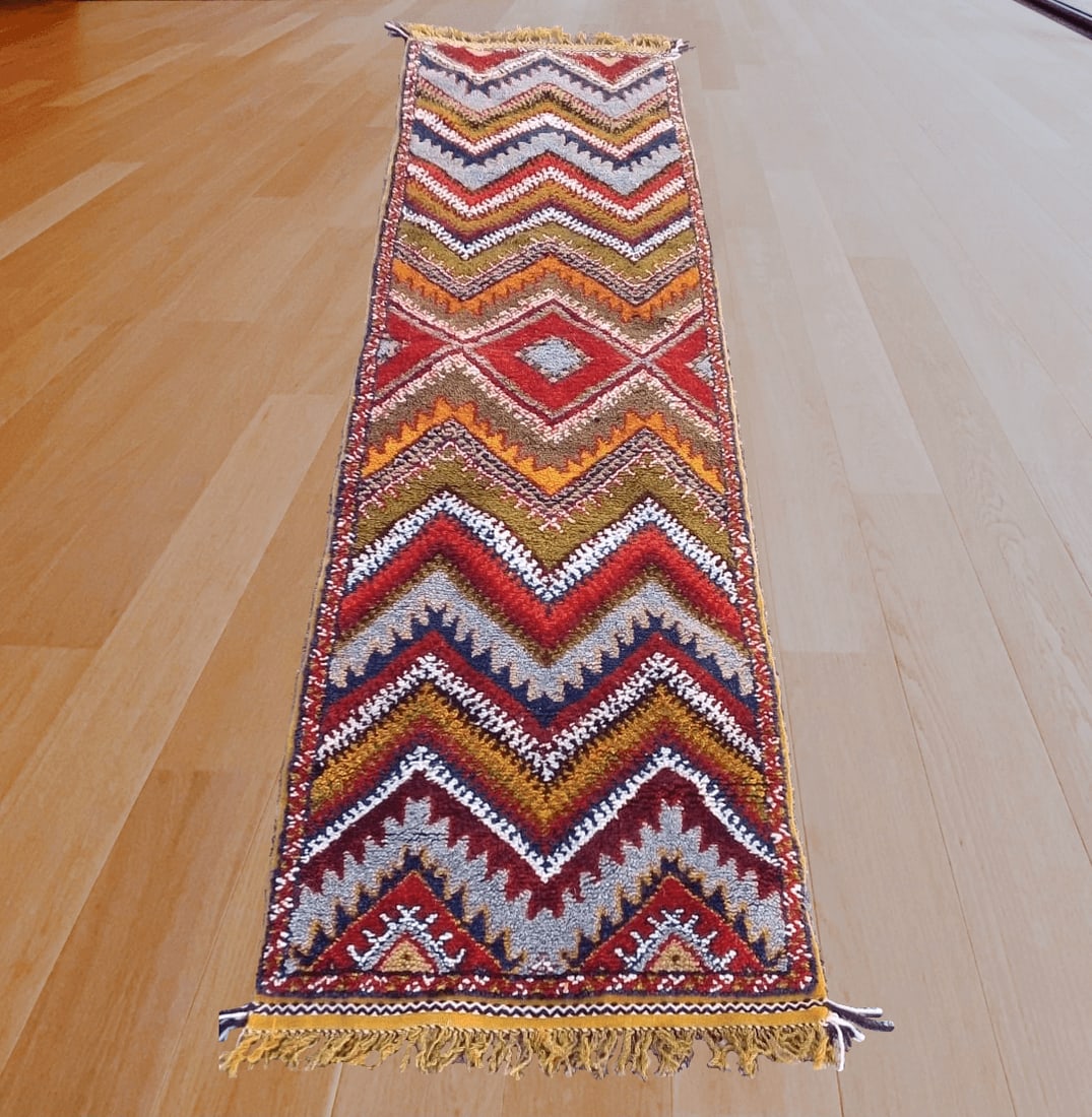 Handmade Wool Moroccan Runner Rug 244 x 69cm Colorful Geometric Design: Handmade Wool Moroccan Runner Rug 244 x 69cm Colorful Geometric Design Elevate your space with this exquisite handmade Moroccan runner rug, featuring a charming colorful geometric pattern that adds vi