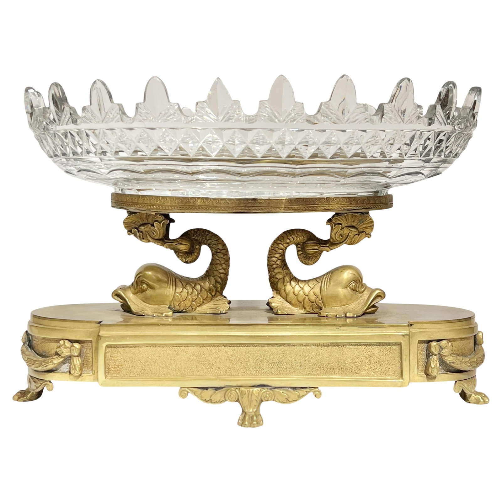 French Empire Revival Gilt Bronze and Cut Glass Oval Centerpiece Bowl c1880s: French Empire Revival Gilt Bronze and Cut Glass Oval Centerpiece Bowl c1880s This late 19th-century French Empire Revival centerpiece features an oval cut glass bowl supported by two stylized dolphins