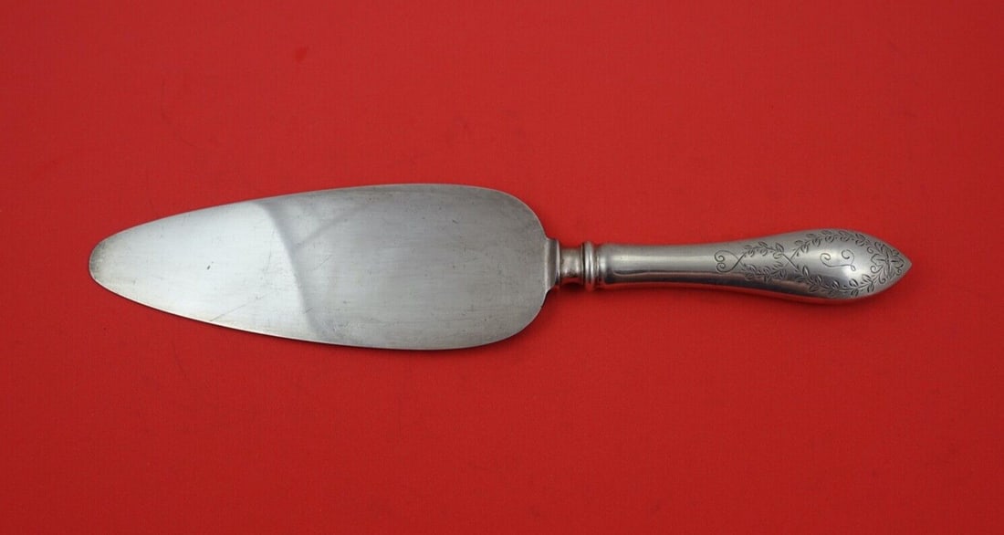 Whiting Colonial A Engraved Sterling Silver Cake Server 10 1/4": Whiting Colonial A Engraved Sterling Silver Cake Server 10 1/4" This exquisite cake/pie server features the Colonial A Engraved pattern by Whiting, crafted from sterling silver. The server boasts a pl