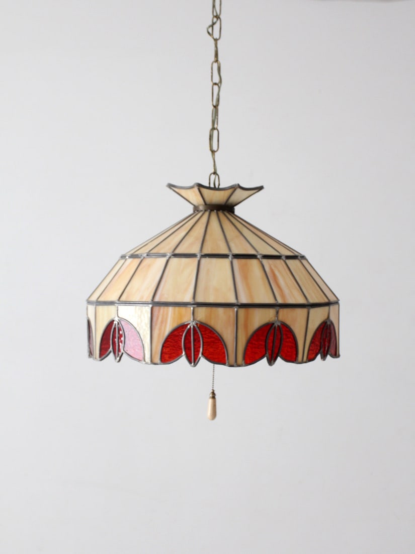 Tiffany style stained glass hanging light with red and cream shade: Tiffany style stained glass hanging light with red and cream shade Vintage stained glass hanging pendant light with warm cream marbled glass, rich red panels, and a scalloped Tiffany-style border. It 