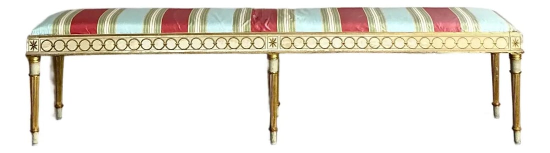 Louis XVI Giltwood Bench with Striped Silk Upholstery 72 Inch Neoclassical Style: Louis XVI Giltwood Bench with Striped Silk Upholstery 72 Inch Neoclassical Style This vintage Neoclassical bench exemplifies the Louis XVI style with its extra-long, six-legged, hand-carved wooden fra