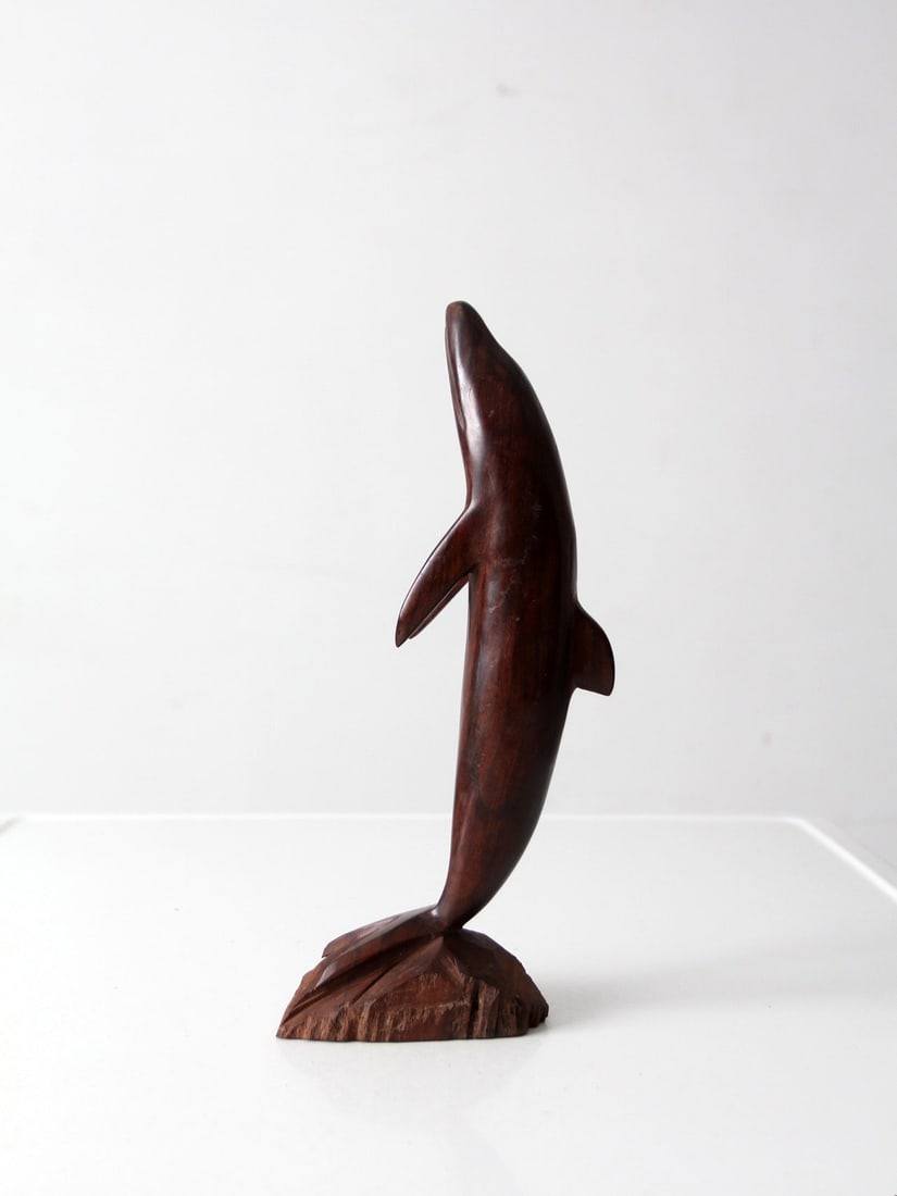 Carved Ironwood Dolphin Figurine 12.5 inch: Carved Ironwood Dolphin Figurine 12.5 inch This mid-century ironwood dolphin sculpture showcases a streamlined, elongated form carved from richly toned dark brown wood. The piece rises from a natural 