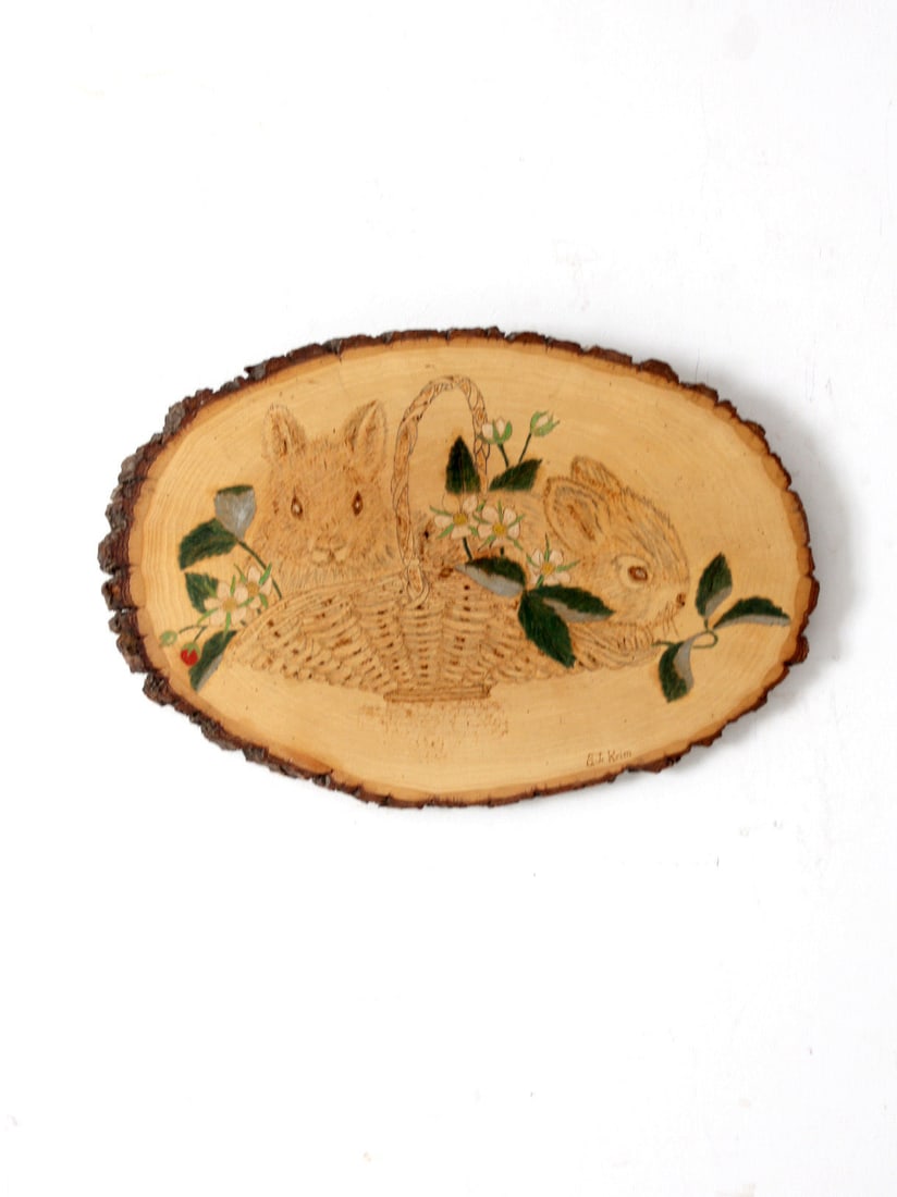 Rustic Vintage Wall Art Wood Slab Bunnies Strawberries Signed: Rustic Vintage Wall Art Wood Slab Bunnies Strawberries Signed This charming vintage wall art is crafted from a natural wood slab, showcasing a hand-etched design of a basket brimming with bunnies and 