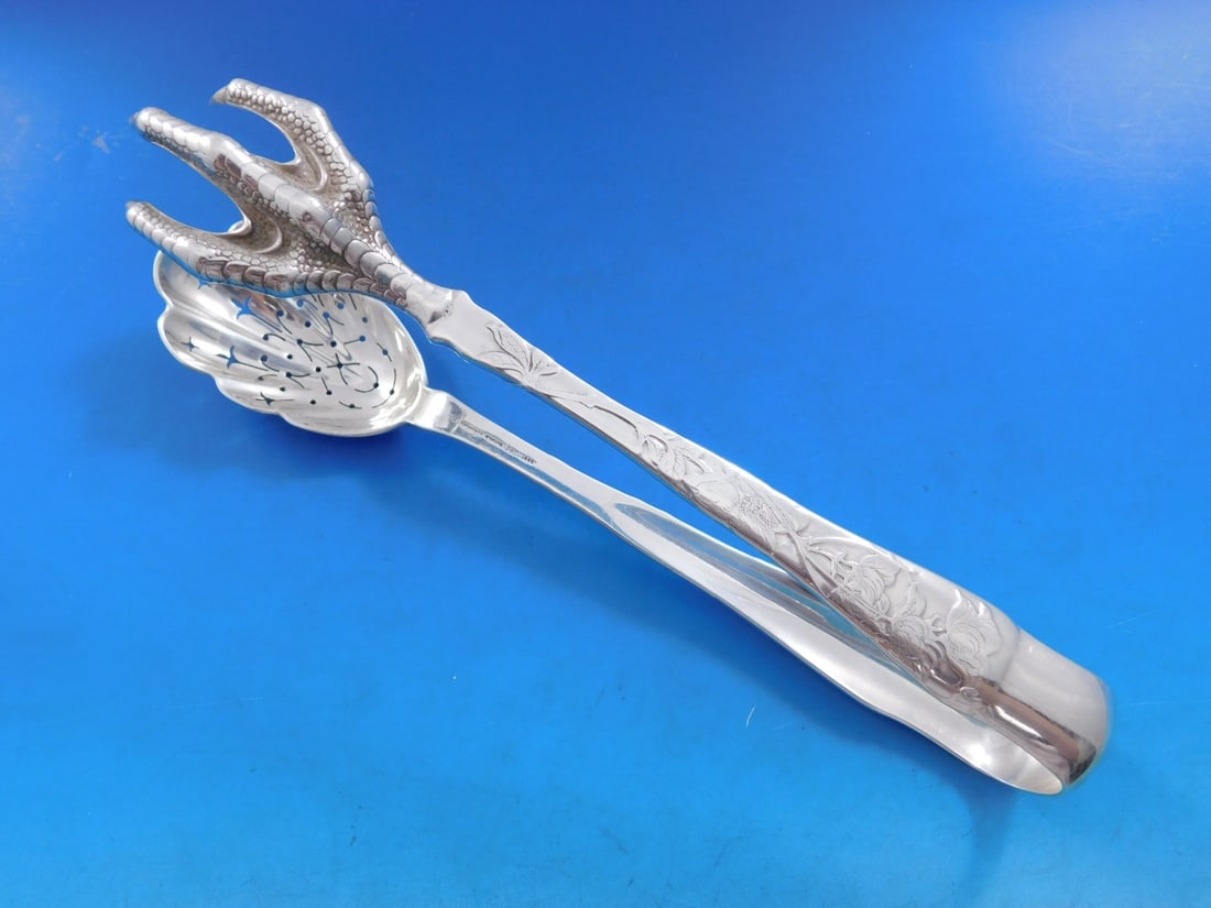 Tiffany & Co. Sterling Silver Ice Tong Lap Over Edge Floral Design 8.5": Tiffany & Co. Sterling Silver Ice Tong Lap Over Edge Floral Design 8.5" This exquisite ice tong from Tiffany & Co. features a stunning Lap Over Edge pattern, masterfully crafted in sterling silver. Th