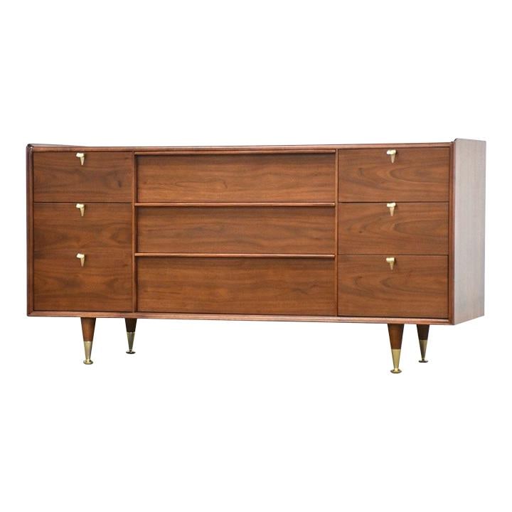 1960s Mid Century Walnut Dresser with Brass Pulls: 1960s Mid Century Walnut Dresser with Brass Pulls This stunning mid-century modern dresser features a beautifully refinished walnut finish and boasts nine spacious drawers, each adorned with elegant b