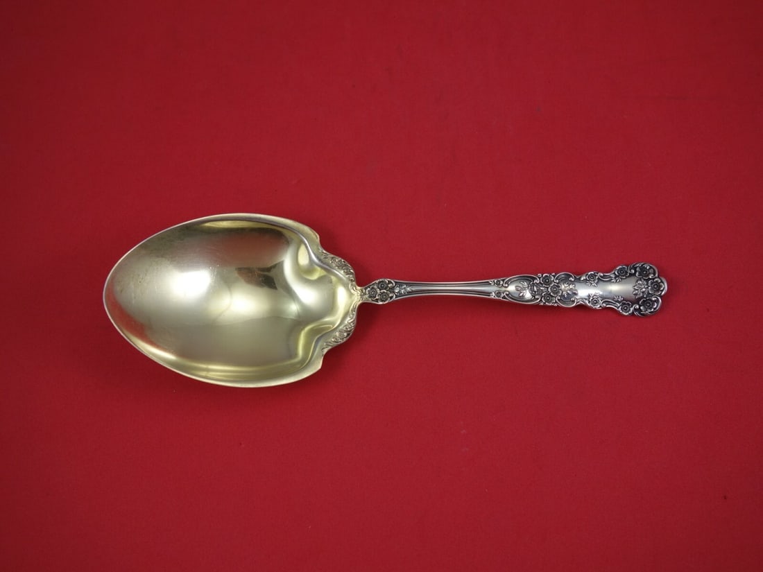 Gorham Buttercup sterling silver berry serving spoon gold washed 7 3/4": Gorham Buttercup sterling silver berry serving spoon gold washed 7 3/4" Sterling silver berry spoon in the Buttercup pattern by Gorham, featuring a gold-washed finish. It is a serving spoon from the 1
