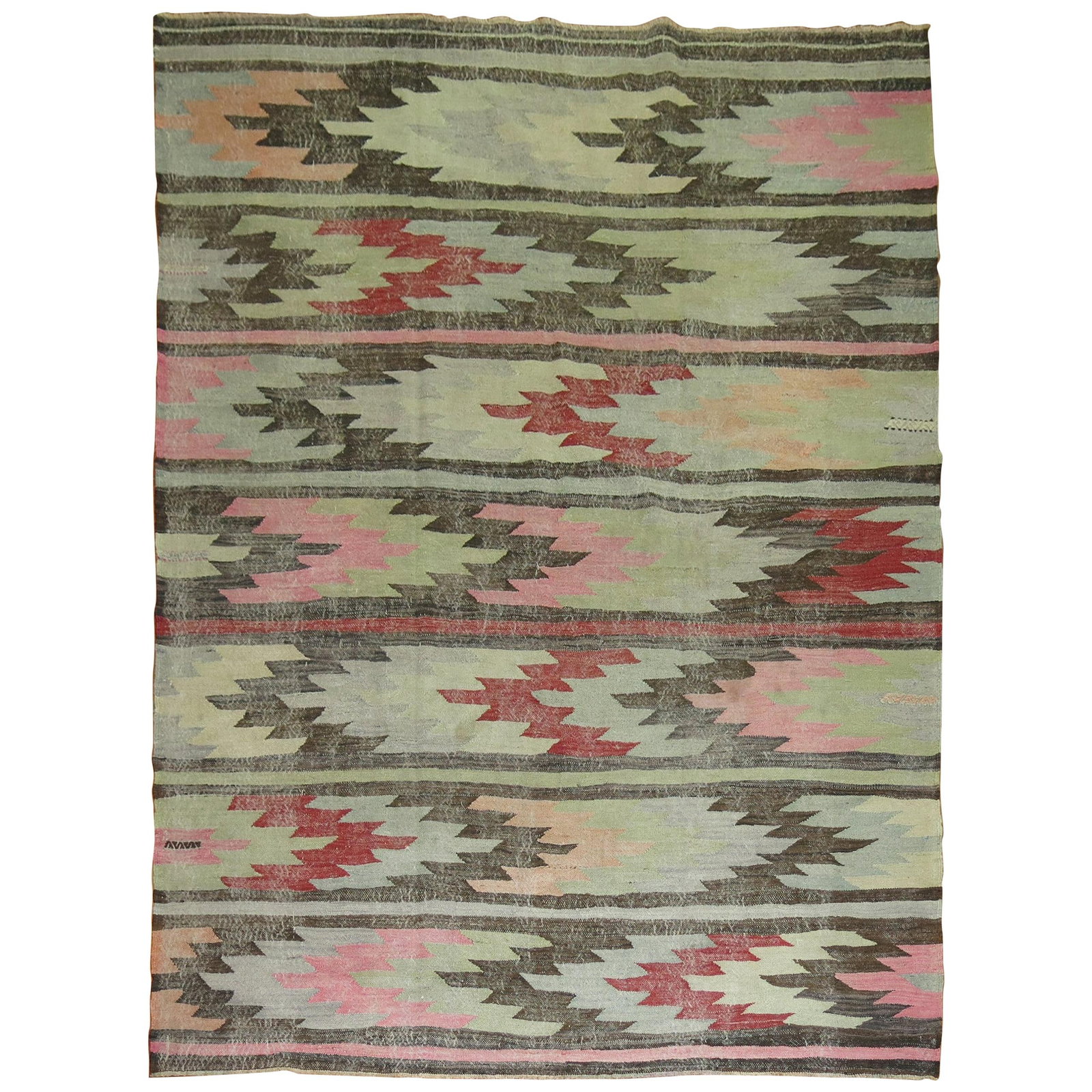 1940s Turkish Tribal Wool Hand Knotted Kilim Rug: 1940s Turkish Tribal Wool Hand Knotted Kilim Rug This mid-20th century Turkish kilim features a tribal design crafted from hand-knotted wool. The rug displays an evenly worn appearance, showcasing a g