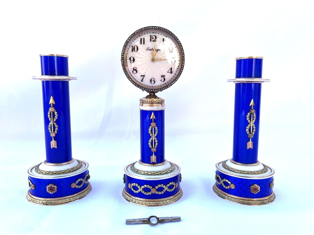 Faberge 14K Gold Diamond Ruby Clock and Candle Stick Set: Faberge 14K Gold Diamond Ruby Clock and Candle Stick Set Introducing a stunning three-piece collection from Faberge, featuring a mechanical clock and a pair of exquisite candle sticks crafted from 14K