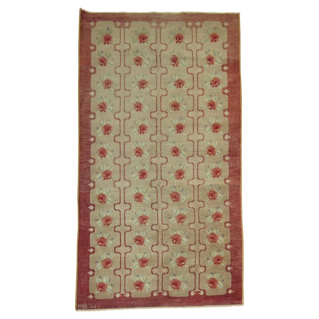 1961 Hand Woven Wool Turkish Konya Floral Rug: 1961 Hand Woven Wool Turkish Konya Floral Rug This vintage Turkish Konya rug, dated 1961, features a romantic style with a repeating floral motif in raspberry tones set against a brown background. Han