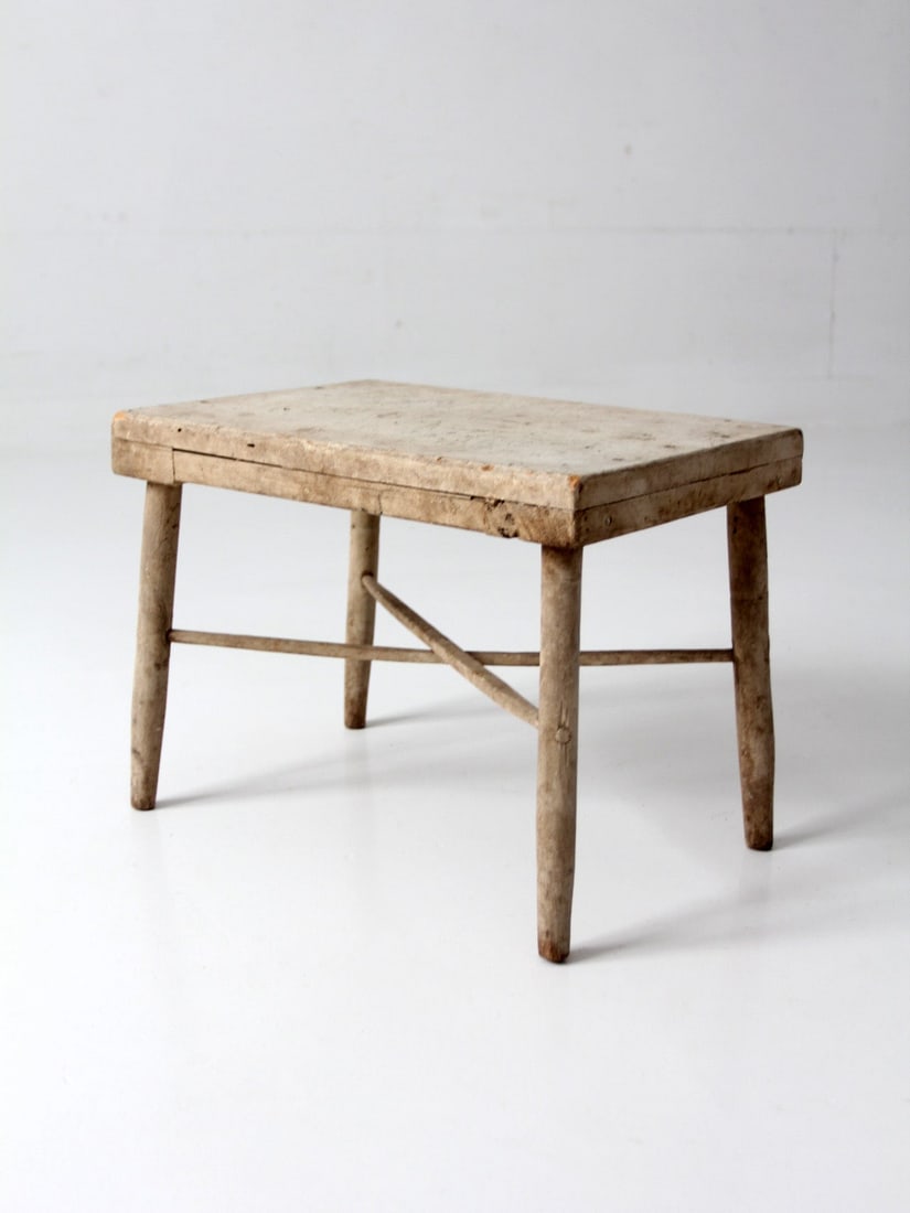 Primitive Painted Farmhouse Stool 17 inch Wide: Primitive Painted Farmhouse Stool 17 inch Wide This antique primitive farmhouse stool features a worn painted surface that highlights its character and history. With an aged finish that adds depth and