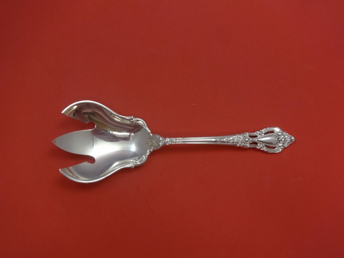 Lunt Eloquence Sterling Silver Salad Serving Fork 9 1/4": Lunt Eloquence Sterling Silver Salad Serving Fork 9 1/4" This Eloquence by Lunt serving fork is crafted from high-quality sterling silver, measuring 9 1/4" in length. The fork features an elegant desi