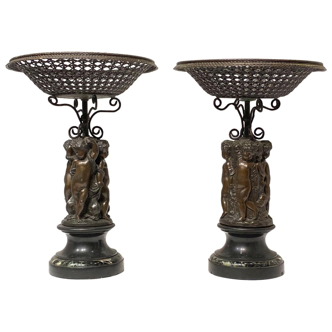 Set of 2 French Bronze Baskets with Cupid Figures on Marble Bases 19th Century: Set of 2 French Bronze Baskets with Cupid Figures on Marble Bases 19th Century This pair of French 19th century corbeilles features patinated bronze construction with detailed depictions of cupids, ea