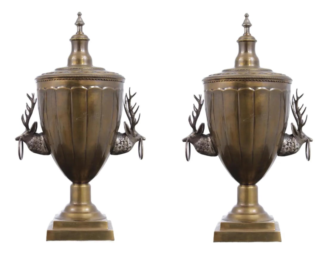 Set of Two Neoclassical Brass Urns with Deer Handles and Lids: Set of Two Neoclassical Brass Urns with Deer Handles and Lids This pair of vintage lidded urns features a neoclassical design crafted from brass with a rich patina. Each urn is adorned with deer or st
