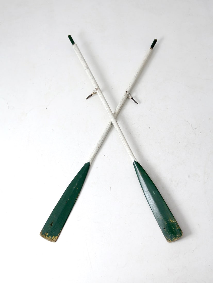 Pair of Vintage Painted Wood Oars with Metal Oarlocks: Pair of Vintage Painted Wood Oars with Metal Oarlocks This pair of vintage painted wooden oars features a striking forest green and white color scheme, enhanced by natural aging that adds to their cha