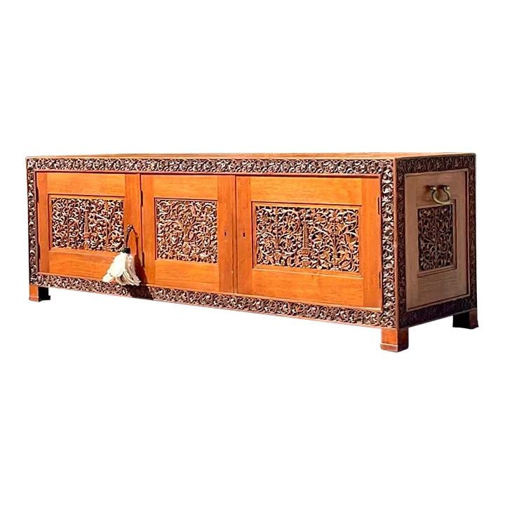 Vintage Boho Teak Credenza with Hand-Carved Details: Vintage Boho Teak Credenza with Hand-Carved Details This exquisite late 20th Century Boho carved teak credenza features stunning hand-carved details and robust brass hardware, providing both style and