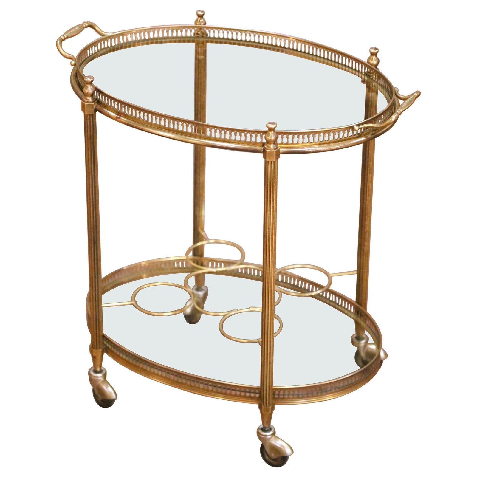 French Art Deco Brass Bar Trolley with Glass Shelf and Bottle Holder Circa 1960: French Art Deco Brass Bar Trolley with Glass Shelf and Bottle Holder Circa 1960 This mid-century French brass oval bar cart showcases elegant neoclassical styling from the mid-20th century. Crafted ci