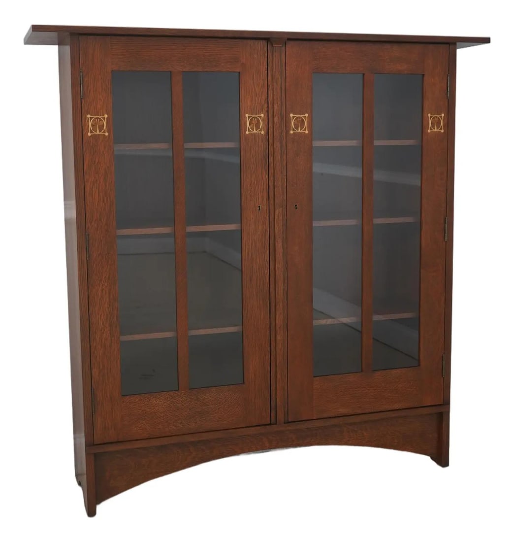 Mission Oak Bookcase in Harvey Ellis Style with Locking Doors: Mission Oak Bookcase in Harvey Ellis Style with Locking Doors This Stickley bookcase features a Harvey Ellis design in the Mission style, crafted from oak with a brown finish. The piece showcases high