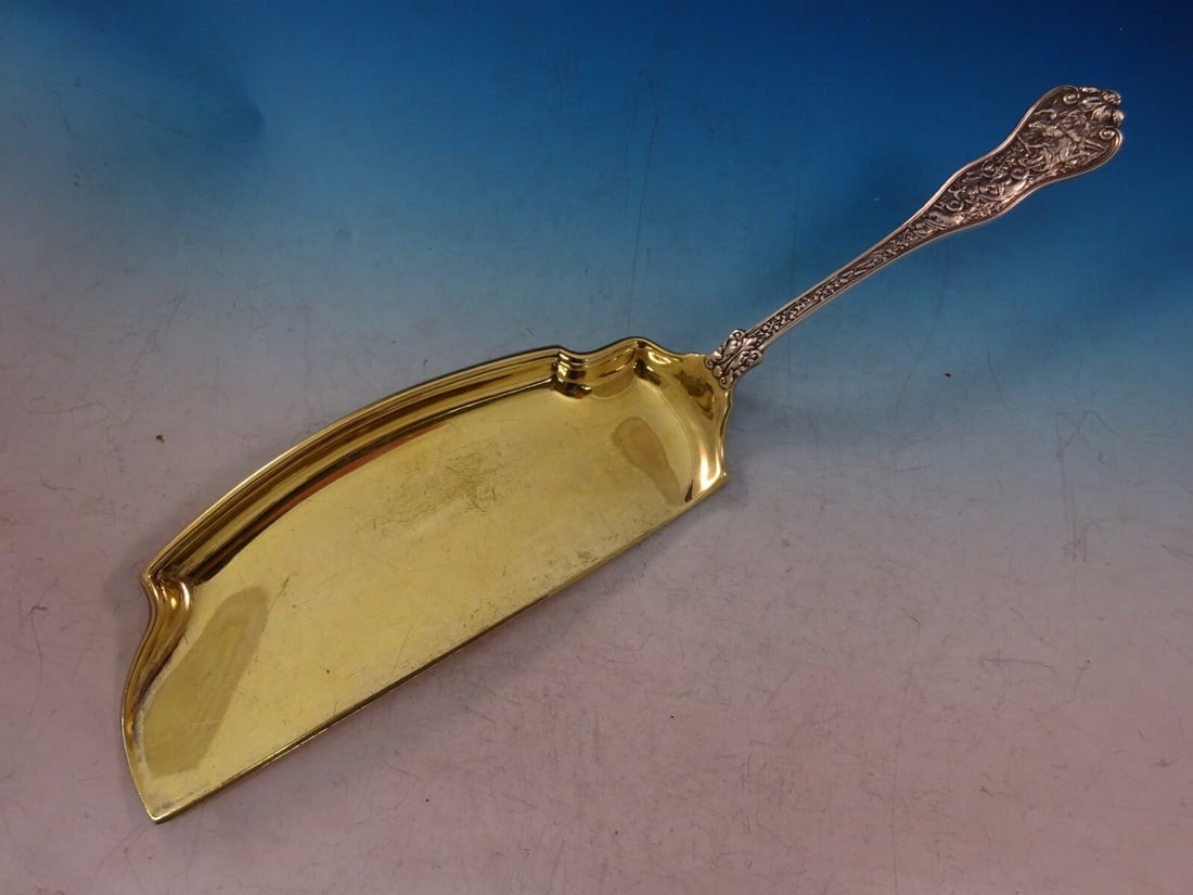 Tiffany & Co Olympian Sterling Silver Crumber 12.5" Gold-Washed Blade: Tiffany & Co Olympian Sterling Silver Crumber 12.5" Gold-Washed Blade Discover the exquisite Olympian Crumber by Tiffany & Co., a stunning piece of sterling silverware crafted in the intricate Olympia