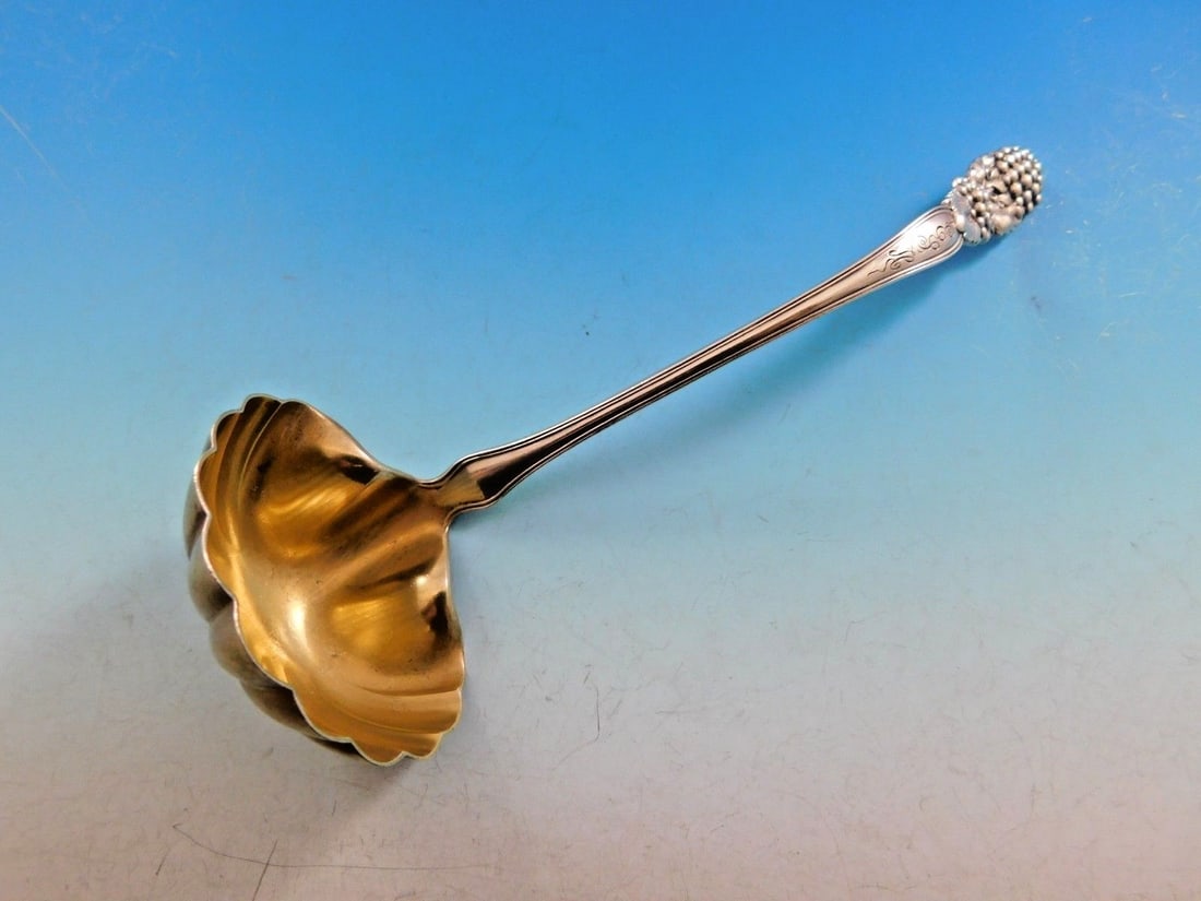 Tiffany & Co Blackberry Sterling Silver Gold-Washed Sauce Ladle 7 1/4": Tiffany & Co Blackberry Sterling Silver Gold-Washed Sauce Ladle 7 1/4" This exquisite ladle from Tiffany & Co. showcases the iconic Blackberry pattern, featuring a charming blackberry motif entwined w