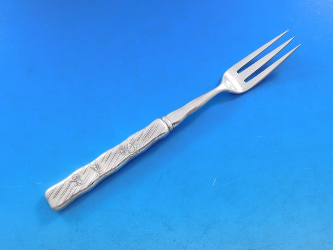 Tiffany Sterling Silver 7" Lap Over Acid Etched Fruit Fork with Maple Leaves: Tiffany Sterling Silver 7" Lap Over Acid Etched Fruit Fork with Maple Leaves This exquisite sterling silver fruit fork features the elegant Lap Over Edge pattern by Tiffany & Co. Crafted between 1850 