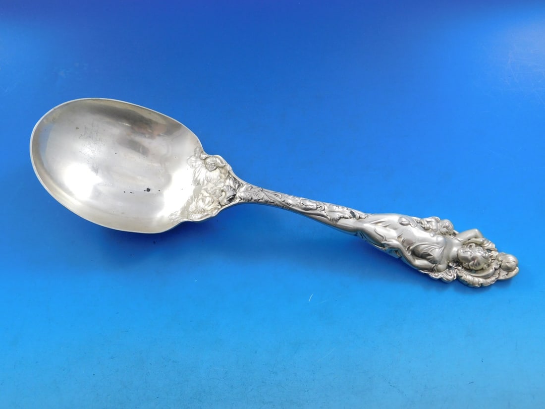 Reed & Barton Love Disarmed Sterling Silver Fluted Berry Spoon 10.5": Reed & Barton Love Disarmed Sterling Silver Fluted Berry Spoon 10.5" This exquisite serving spoon is a stunning example of the Love Disarmed pattern by Reed and Barton. Crafted from sterling silver, i
