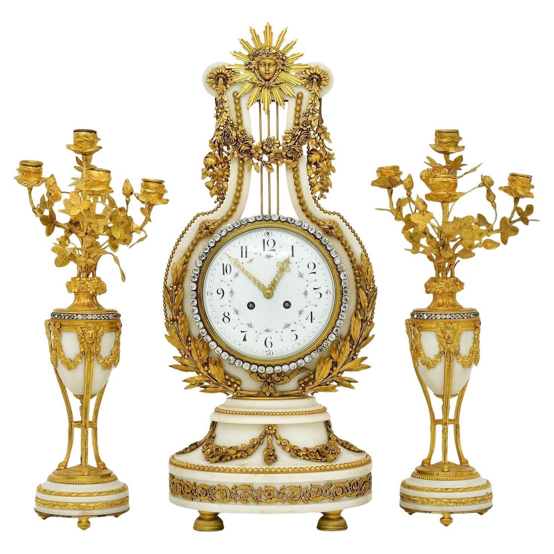 French Louis XIV Style White Marble Bronze Clock and Candelabra Set of 3: French Louis XIV Style White Marble Bronze Clock and Candelabra Set of 3 This late 19th century French garniture set, crafted in the Louis XIV style, features a mantel clock and a pair of candelabra. 