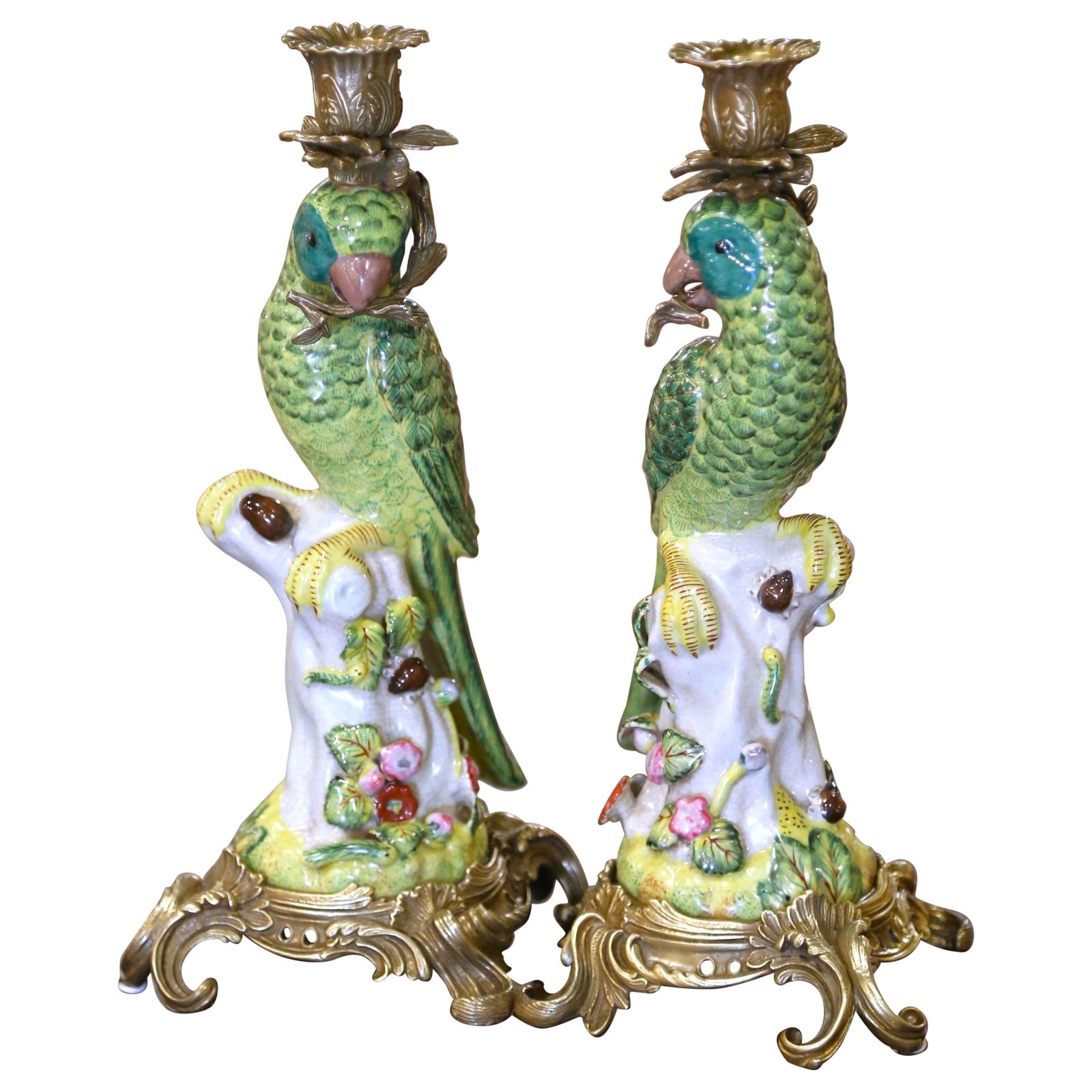Pair of Louis XV Style Porcelain Parrot Candleholders with Gilt Bronze Bases: Pair of Louis XV Style Porcelain Parrot Candleholders with Gilt Bronze Bases This pair of mid-century candlesticks features vividly hand-painted porcelain parrots perched atop floral-covered tree stum