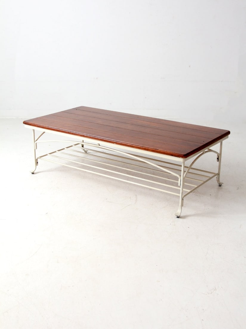 Vintage Wood Iron Coffee Table with Slatted Shelf 52x26: Vintage Wood Iron Coffee Table with Slatted Shelf 52x26 This vintage coffee table combines a sturdy iron base with elegantly curved legs and a spacious slatted lower shelf for convenient open storage.
