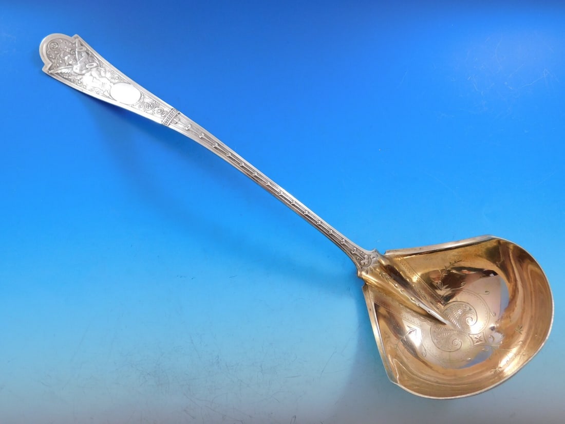 Shiebler Cupid Sterling Silver Soup Ladle 13 inch Gold Wash: Shiebler Cupid Sterling Silver Soup Ladle 13 inch Gold Wash Introducing the Cupid Soup Ladle by Shiebler, a stunning piece crafted from high-quality sterling silver. This ladle features a beautifully 