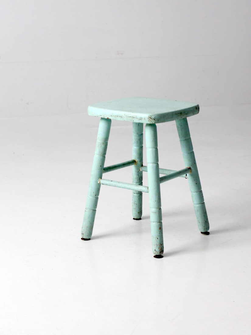Turquoise Vintage Wooden Stool with Turned Splay Legs: Turquoise Vintage Wooden Stool with Turned Splay Legs This vintage painted wooden stool features a vibrant turquoise blue finish, perfect for adding a pop of color to any space. It is designed with ch