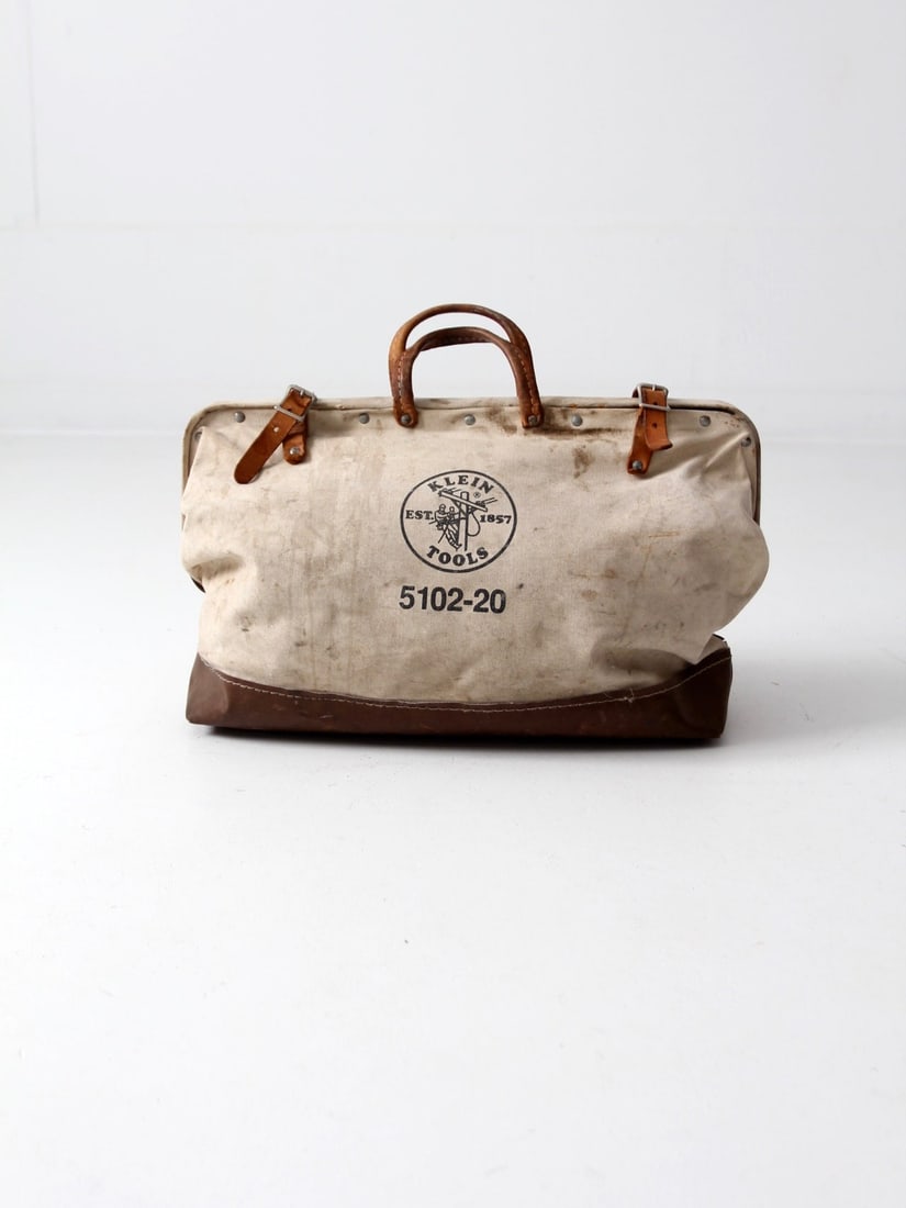 Vintage Klein Tools Canvas Work Bag with Metal Frame and Leather Closures: Vintage Klein Tools Canvas Work Bag with Metal Frame and Leather Closures Discover the charm of this vintage Klein Tools canvas bag, designed for linemen and crafted for durability. Featuring a sturdy