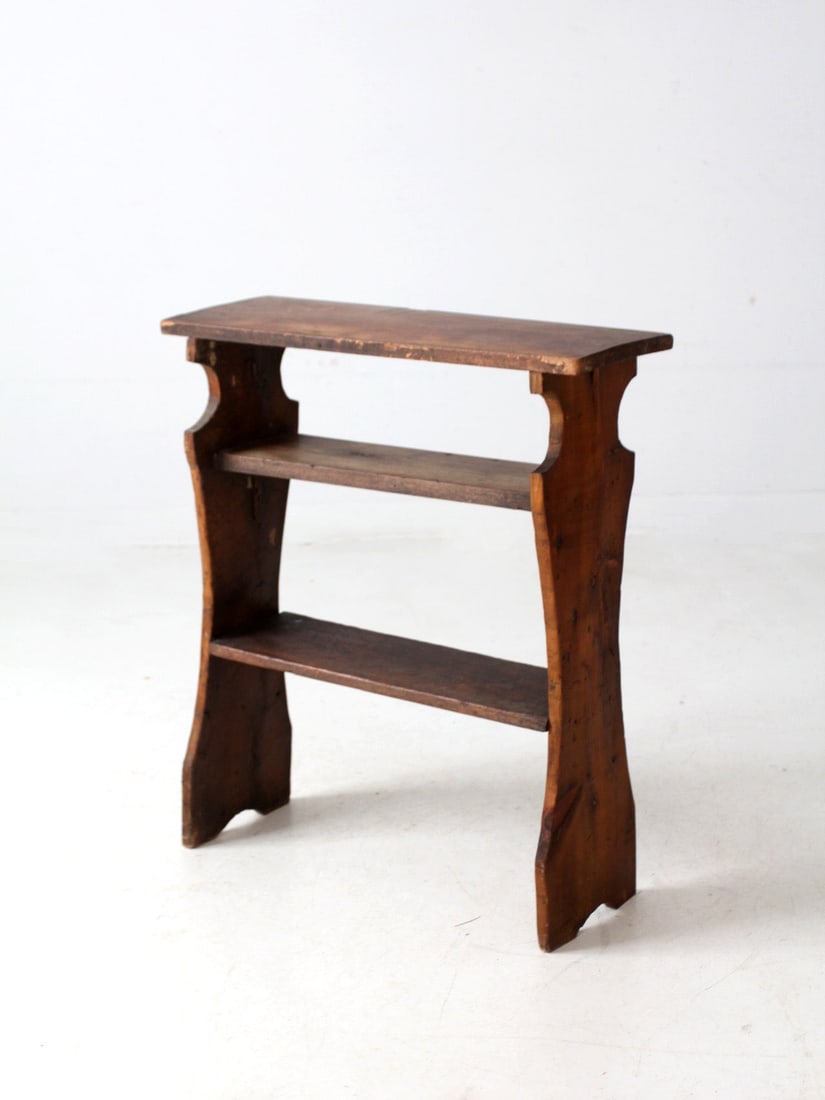 Rustic Antique Handmade Pine Shelf Three-Tier Design: Rustic Antique Handmade Pine Shelf Three-Tier Design This antique handmade pine shelf showcases beautifully sculpted side panels and visible shaping marks, exuding a warm, aged finish that enhances it