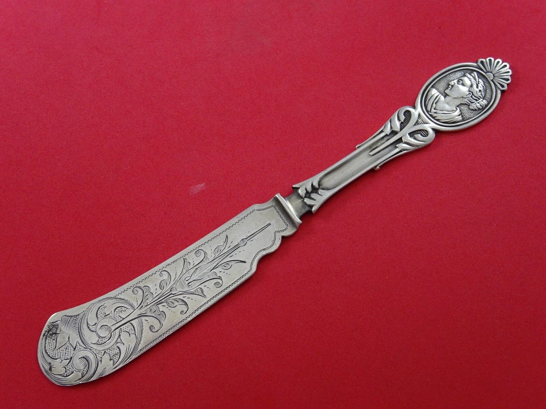 Wood & Hughes Medallion Diana Coin Silver Master Butter Knife Engraved 7 3/8": Wood & Hughes Medallion Diana Coin Silver Master Butter Knife Engraved 7 3/8" This exquisite master butter knife, crafted by Wood & Hughes, features the elegant Medallion pattern, also known as Diana.