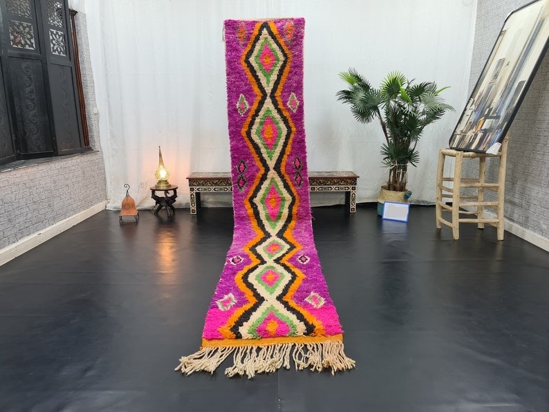 Authentic Moroccan Pink Wool Runner Rug 2 x 10 Feet: Authentic Moroccan Pink Wool Runner Rug 2 x 10 Feet Experience the charm of authentic craftsmanship with this Stunning Pink Handmade Moroccan Berber Wool Runner Rug. Handwoven by skilled Berber women 