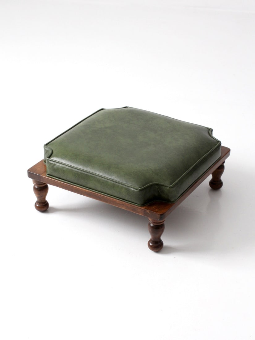 Colonial Revival Wooden Footstool With Green Faux Leather Cushion: Colonial Revival Wooden Footstool With Green Faux Leather Cushion This mid-20th century Colonial Revival footstool features a square wood base with turned bun feet and a tailored green faux leather cu