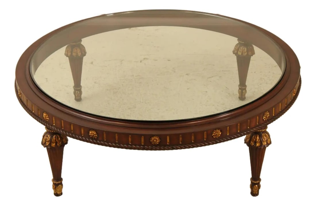 French Style Round Coffee Table With Thick Glass Top And Carved Gold Accents: French Style Round Coffee Table With Thick Glass Top And Carved Gold Accents This large round coffee cocktail table features a thick glass top and showcases French style design elements with elegant c