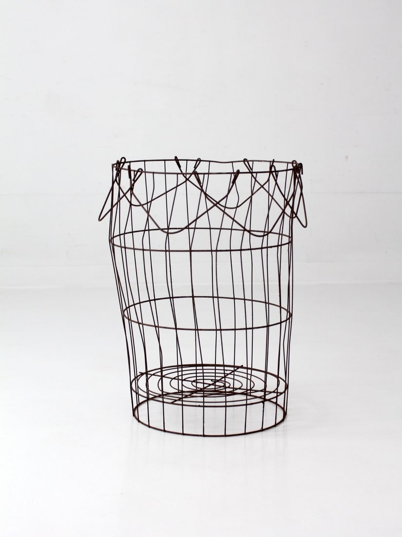 Handcrafted Antique Metal Produce Basket With Sculptural Form: Handcrafted Antique Metal Produce Basket With Sculptural Form This antique wire gathering basket features a hand-shaped wire frame with a generous, upright form and a looping rim that folds inward, re