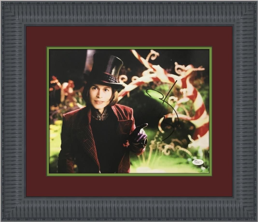 Johnny Depp Signed Willy Wonka Photo Custom Framed JSA 17 x 20: Johnny Depp Signed Willy Wonka Photo Custom Framed JSA 17 x 20 This stunning custom-framed photograph captures Johnny Depp in his iconic role as Willy Wonka. The 11" x 14" original photograph is exper