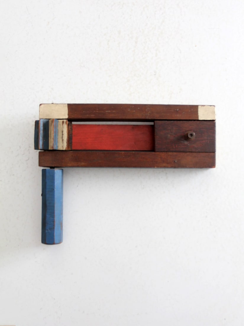 Vintage Early 20th Century Wooden Noisemaker Americana Folk Art: Vintage Early 20th Century Wooden Noisemaker Americana Folk Art This early 20th-century wooden noisemaker is a striking example of Americana folk art, featuring a vibrant paint scheme of bold red, whi