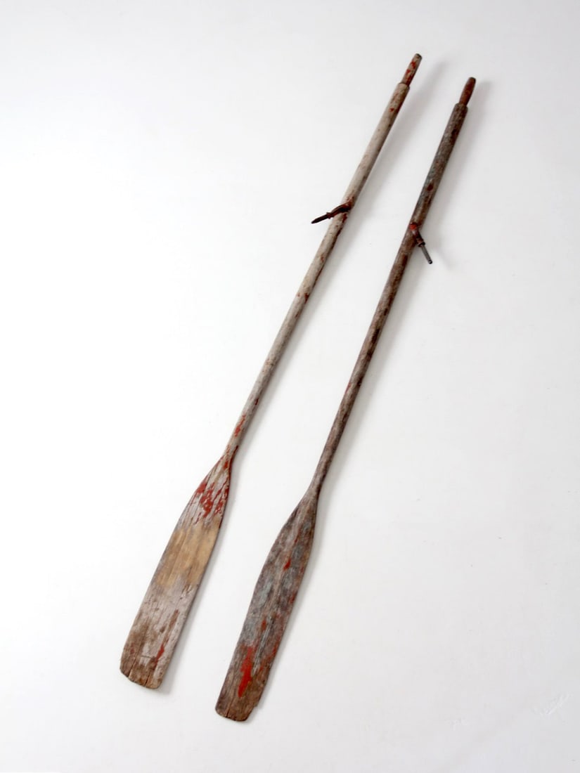 Pair of 82 Inch Vintage Wood Boat Oars with Metal Oarlock Stops: Pair of 82 Inch Vintage Wood Boat Oars with Metal Oarlock Stops A vintage pair of wooden boat oars with long narrow blades, aged painted surfaces, and original metal oarlock stops. Their sculptural fo