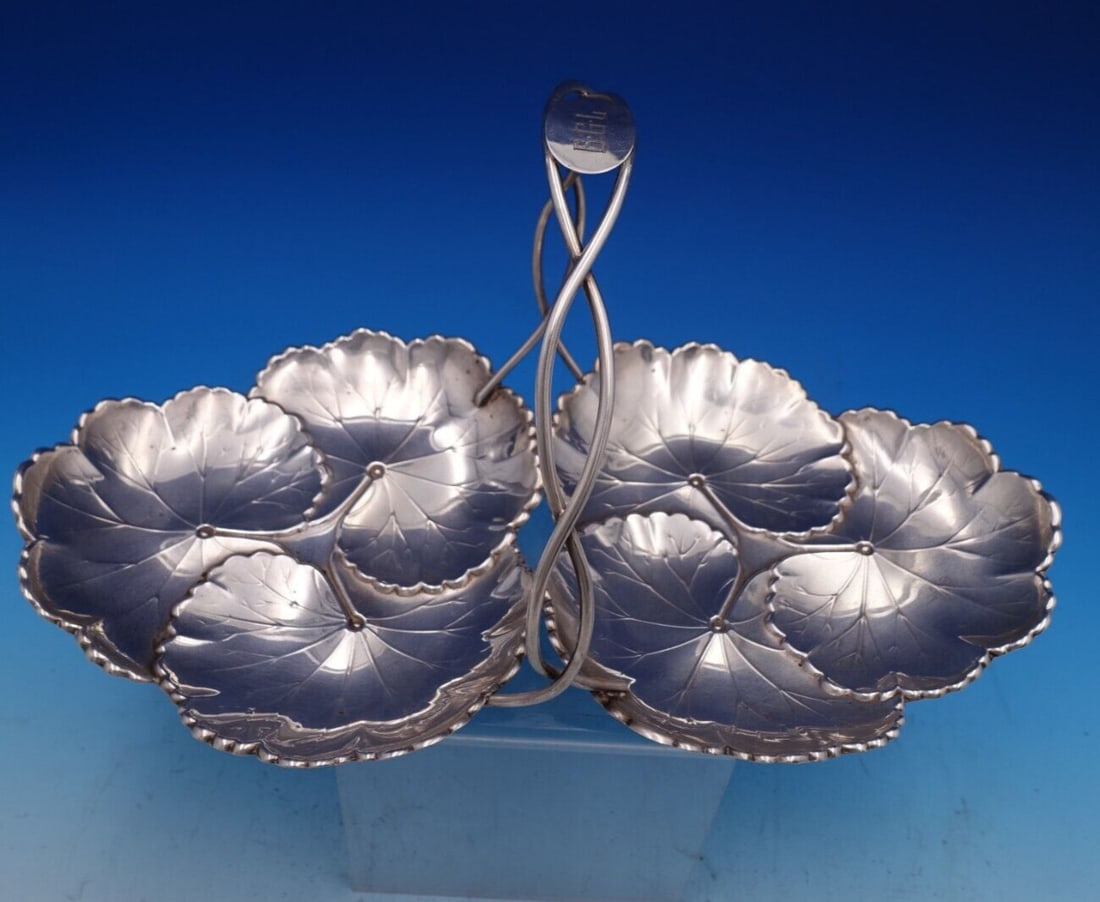 Reed and Barton Sterling Silver Leaf Handle Candy Dish 13.25": Reed and Barton Sterling Silver Leaf Handle Candy Dish 13.25" This exquisite candy dish from Reed and Barton showcases a stunning leaf motif and features a practical handle for ease of use. Crafted fr