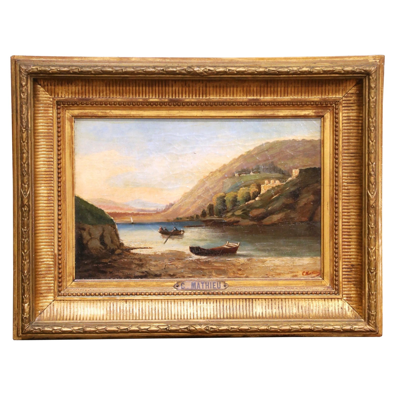 Signed French Coastal Landscape on Canvas in Giltwood Frame: Signed French Coastal Landscape on Canvas in Giltwood Frame This mid-19th century French landscape painting, signed by C. Mathieu, beautifully captures a tranquil coastal cove scene. Painted circa 187