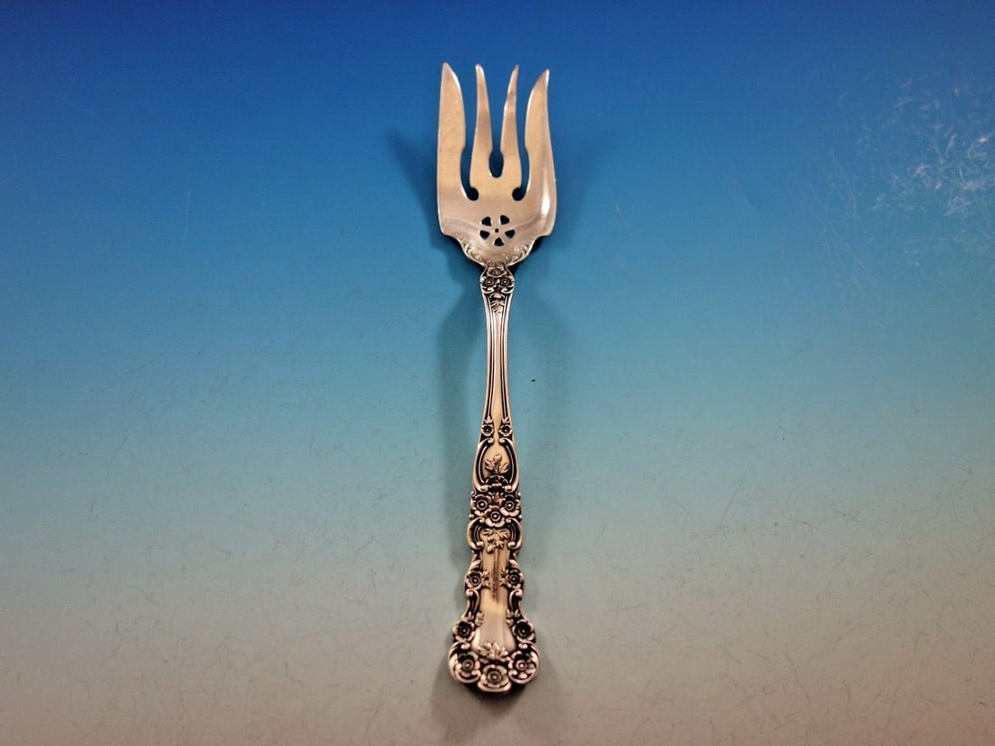 Gorham Buttercup Sterling Silver Pierced Serving Fork 6 7/8": Gorham Buttercup Sterling Silver Pierced Serving Fork 6 7/8" This exquisite Buttercup serving fork by Gorham is a stunning addition to any table setting. Crafted from high-quality sterling silver, thi