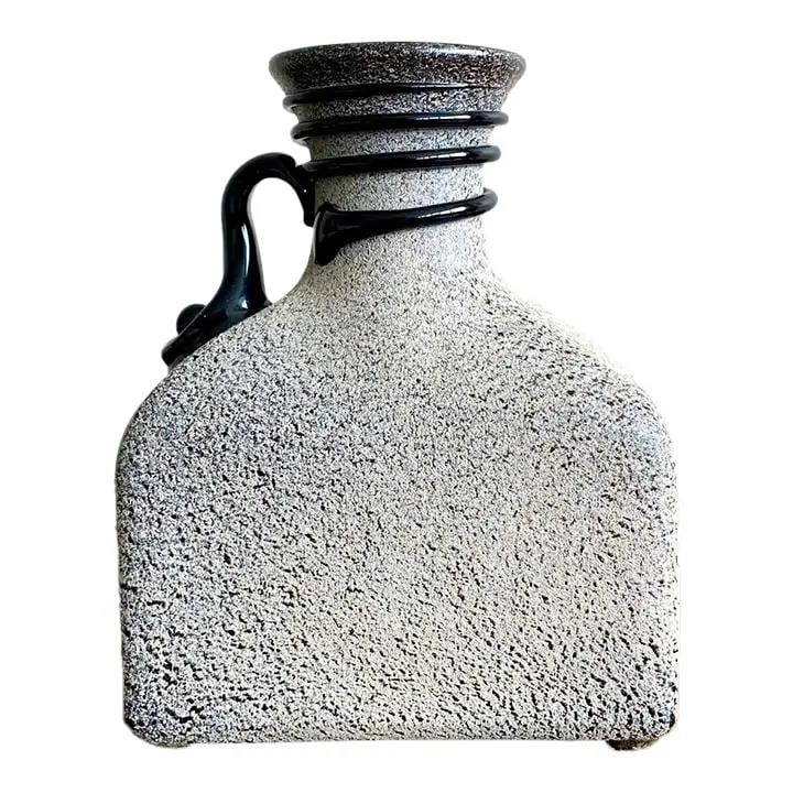 Vintage Boho Studio Pottery Vase Greige Glossy Black Accents: Vintage Boho Studio Pottery Vase Greige Glossy Black Accents This vintage Boho studio pottery vase is a striking piece, characterized by its bold, sculptural form. The bottle silhouette showcases a ra