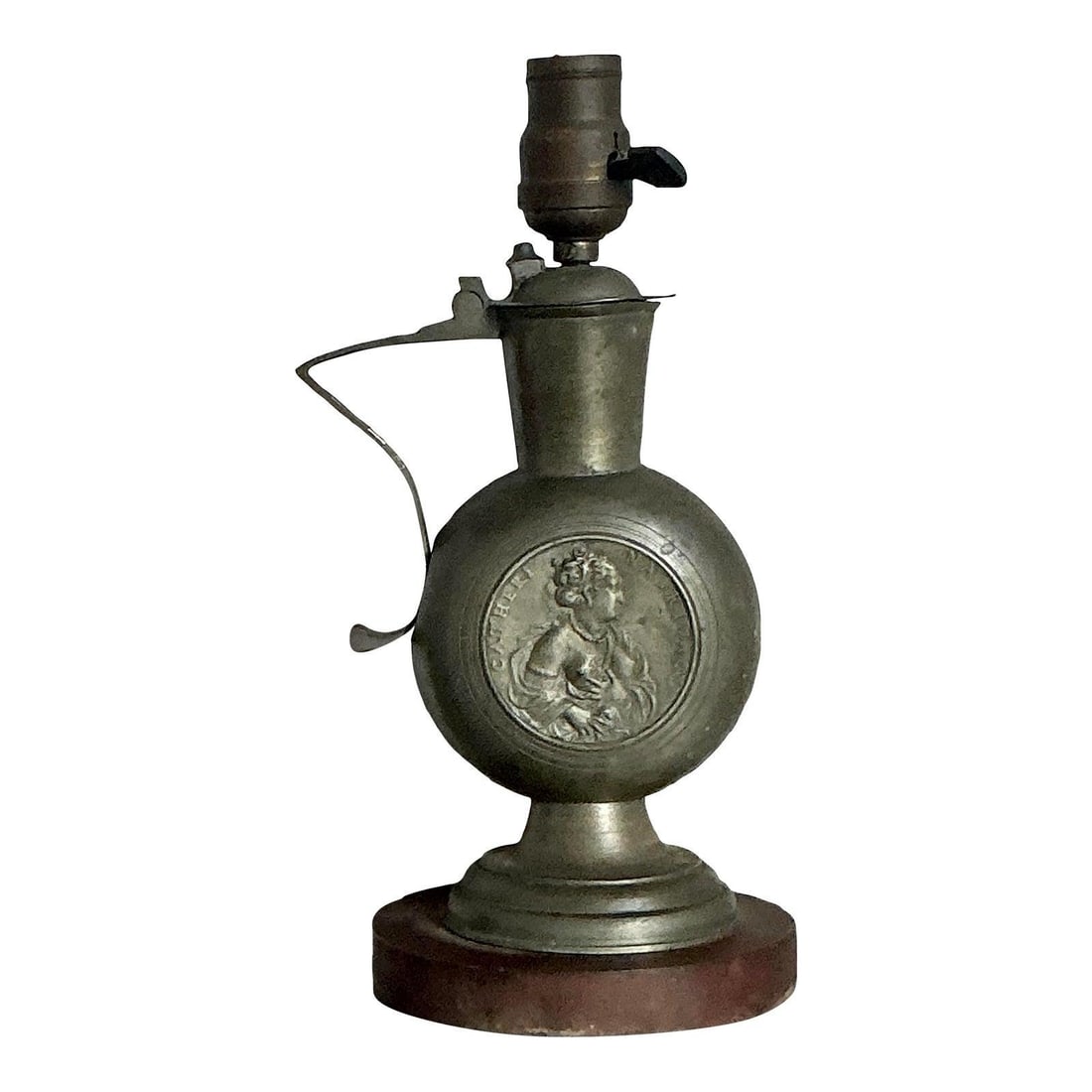 Midcentury Pewter Tone Embossed Metal Table Lamp with Figural Medallion: Midcentury Pewter Tone Embossed Metal Table Lamp with Figural Medallion This vintage table lamp features an embossed metal body with a pewter-tone finish, showcasing a rustic Boho style from the mid-2