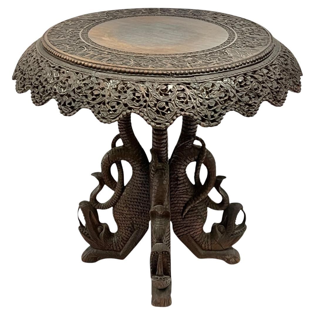 Late 1800s Hand-Carved Wood Table with Dragon and Snake Legs: Late 1800s Hand-Carved Wood Table with Dragon and Snake Legs This antique side table from the late 19th century is likely of Burmese or South Asian origin. Crafted from wood, it features intricate han