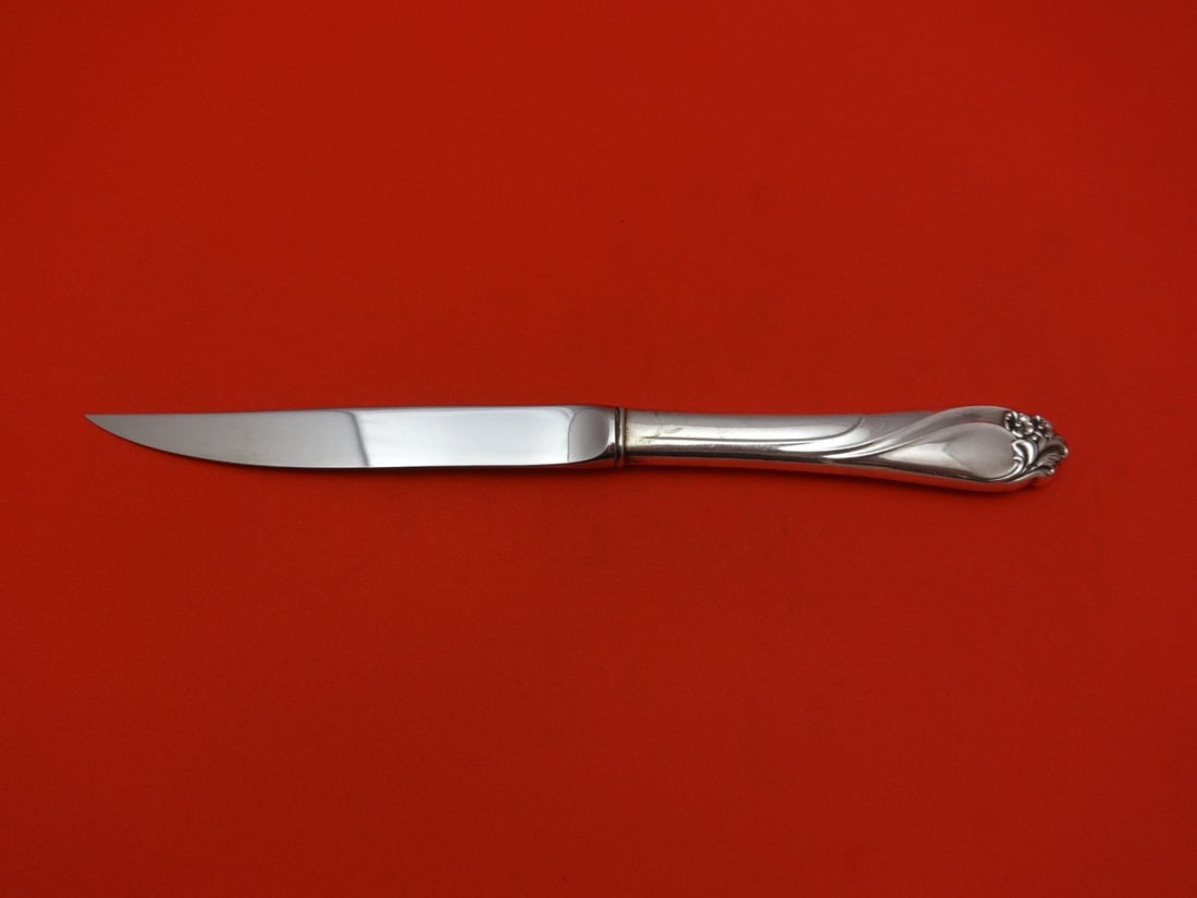 International Enchanted Rose sterling silver steak knife 8 3/4": International Enchanted Rose sterling silver steak knife 8 3/4" Sterling silver steak knife in the Enchanted Rose pattern by International. It features a sterling silver hollow handle with a stainless