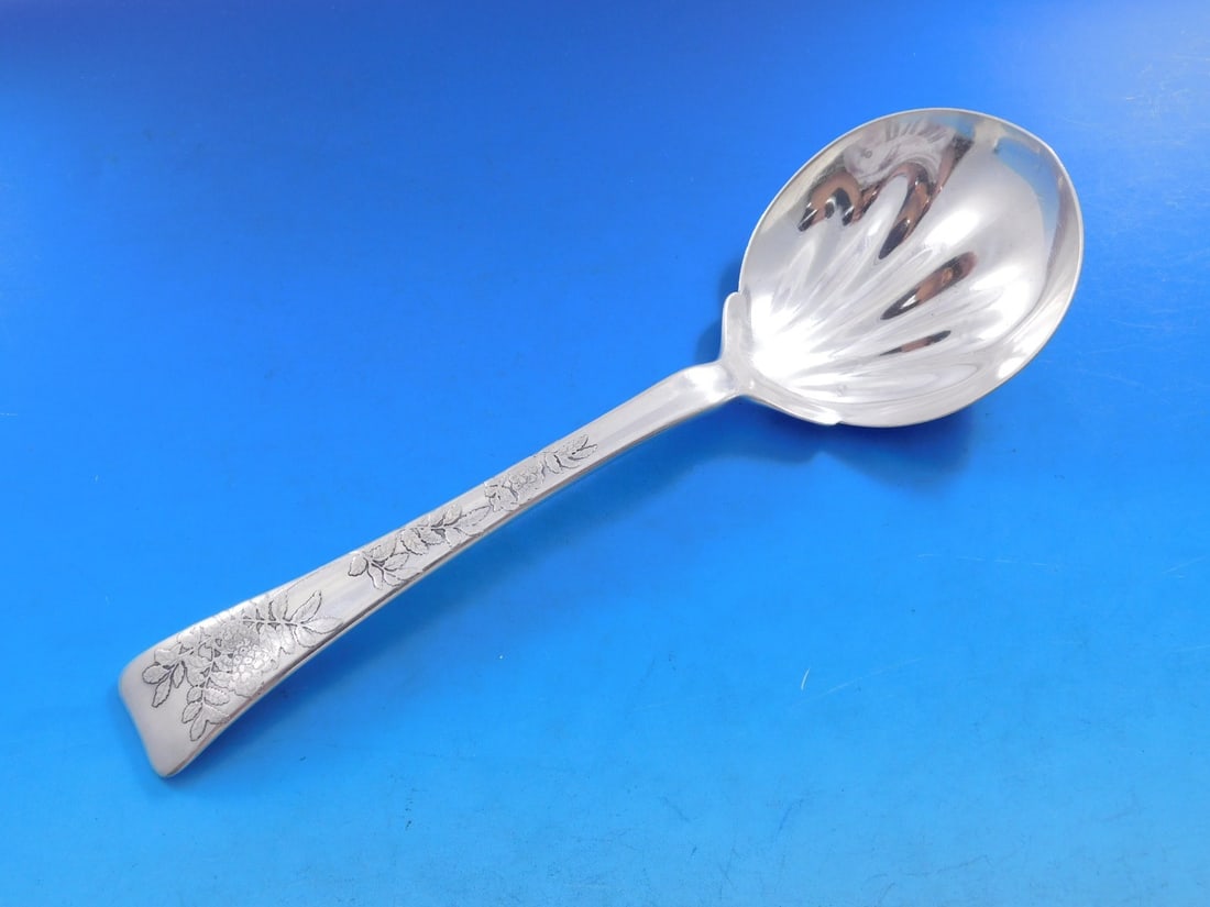 Tiffany Sterling Silver 9" Lap Over Edge Berry Spoon Raspberry Motif: Tiffany Sterling Silver 9" Lap Over Edge Berry Spoon Raspberry Motif This exquisite 9" berry spoon from Tiffany & Co. features the elegant Lap Over Edge Acid Etched pattern. Crafted from high-quality 