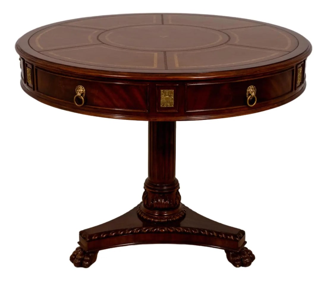 Round Leather Top Center Table with Drawers and Brass Lion Pulls: Round Leather Top Center Table with Drawers and Brass Lion Pulls This center table features a round, tooled leather top set on a platform pedestal base. It includes two drawers with brass lion head pu
