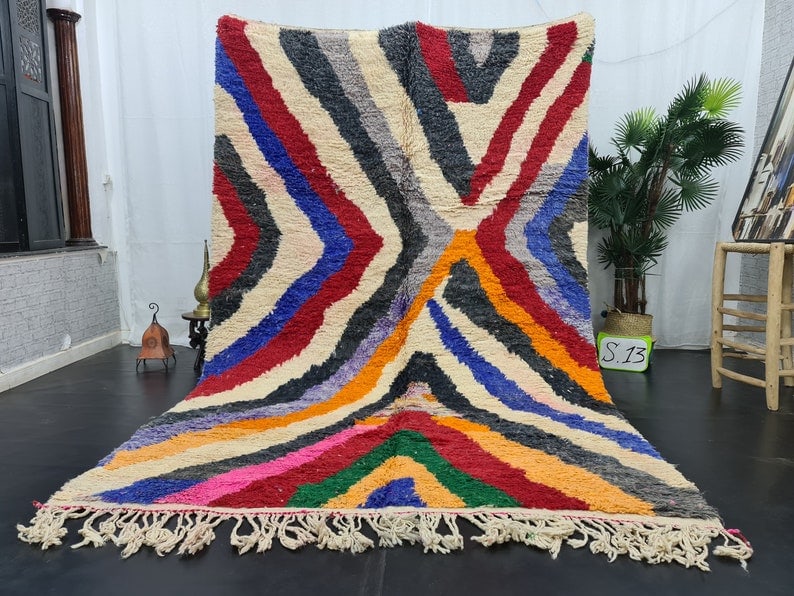 Handmade Moroccan Berber Wool Rug 9.84 x 5 Feet: Handmade Moroccan Berber Wool Rug 9.84 x 5 Feet Experience the beauty of the Atlas Mountains with this stunning handmade Moroccan Berber wool area rug. Crafted by skilled local Berber women weavers, t